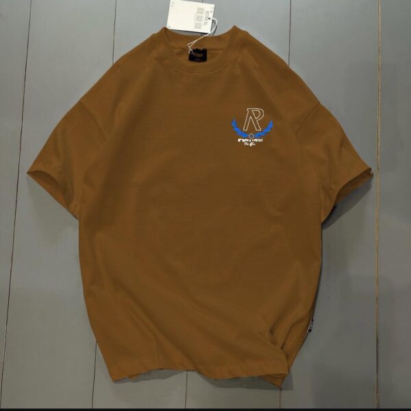 **Alt Text:** Oversized drop shoulder t-shirt with bold front and back "R" print, made from soft PC Jersey fabric. Available in black, brown, and grey, in sizes medium, large, and extra large.